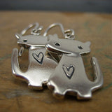 close up of pair Sterling Silver Little Charm Space Cat Earrings by Mark Poulin